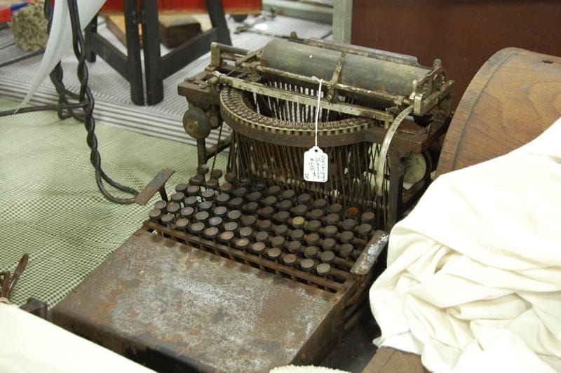 Vintage typewriter with ornate brass detailing on display at the show
